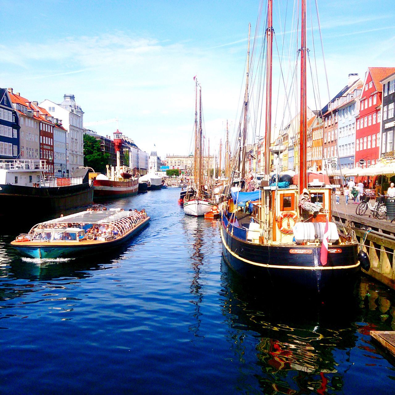 nautical vessel, boat, moored, transportation, water, mode of transport, building exterior, waterfront, architecture, built structure, harbor, sky, mast, canal, sailboat, reflection, city, travel, river, outdoors