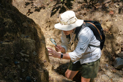 Rear view of man standing on rock