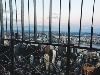 High angle view of cityscape by sea against sky