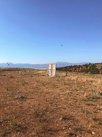 Scenic view of field against clear blue sky