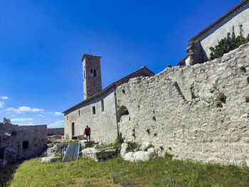 Low angle view of old building against blue sky