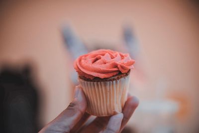 Close-up of hand holding cupcake