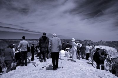 Tourists standing on rock formation