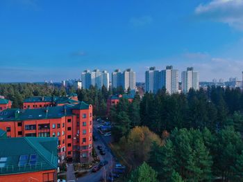 High angle view of buildings against blue sky