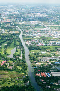 High angle view of field in city against sky