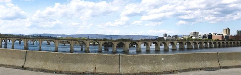 Panoramic view of bridge over river against cloudy sky