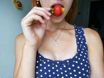 Close-up of young woman eating strawberry