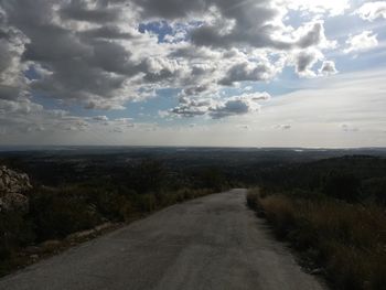 Road by sea against sky