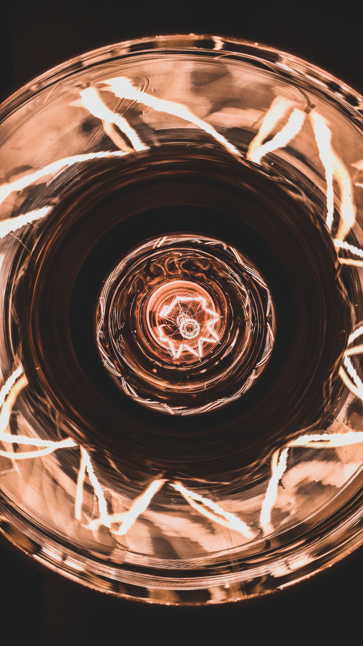 HIGH ANGLE VIEW OF ILLUMINATED COFFEE BEANS IN GLASS