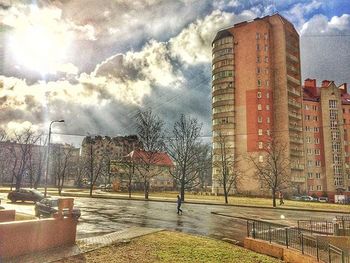 Buildings against cloudy sky