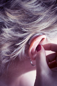 Close-up portrait of woman with hand