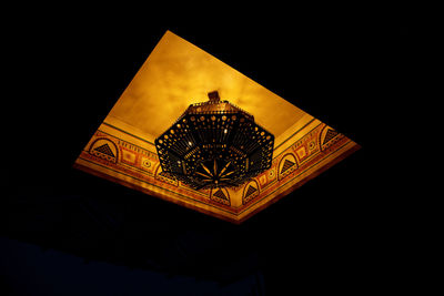 Low angle view of illuminated lantern against building