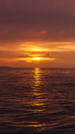 Scenic view of sea against orange sky