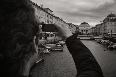 Silhouette of woman standing against cityscape