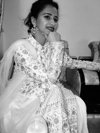 Portrait of woman sitting at home