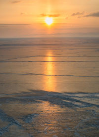 Scenic view of sea against orange sky