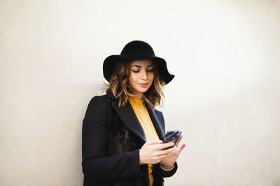 Smiling woman using phone