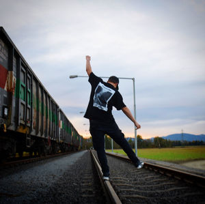 Man standing on railroad track