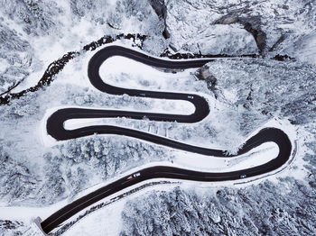 High angle view of winding road on snowcapped landscape