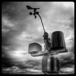 Low angle view of street light against cloudy sky