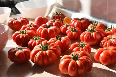 Red ripe tomatoes, on a table ready to be prepared in a nice dish for lunch or dinner.