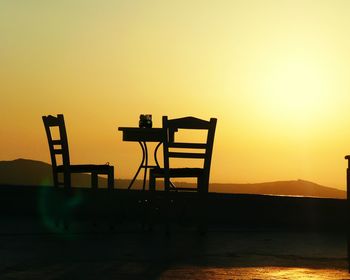 Chairs on chair at sunset