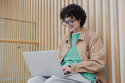 Young businesswoman using laptop while sitting at home