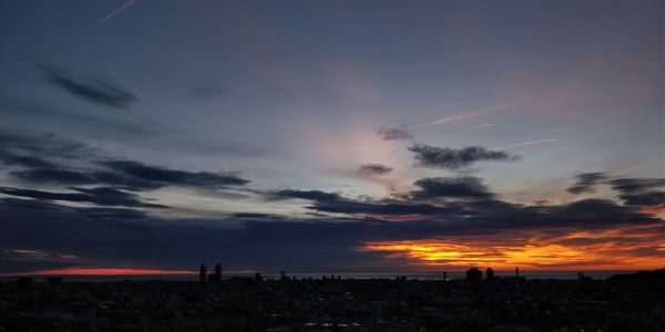 Silhouette of city at sunset