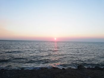 Scenic view of sea against clear sky during sunset