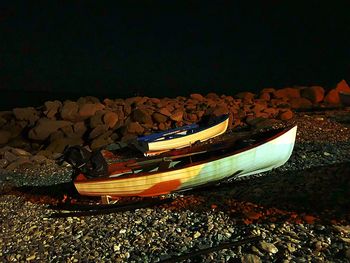 High angle view of boats moored on beach against sky at night