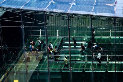 People in modern glass building