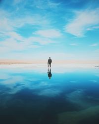 Full length of man walking at beach against sky