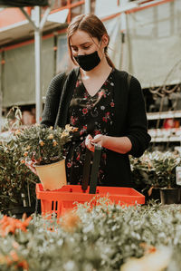 Young woman holding while standing outdoors