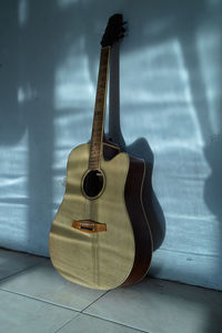 Close-up of guitar against wall