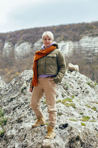 Full length of woman standing on rock