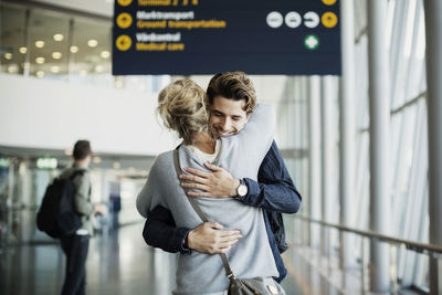 Happy businessman embracing colleague at airport