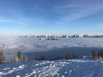 Scenic view of snowcapped mountains against blue sky