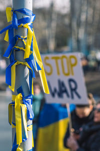 Ribbons with colors of ukraine during a peaceful demonstration against war, putin and russia