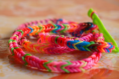 Close-up of colorful rubber band bracelet on table