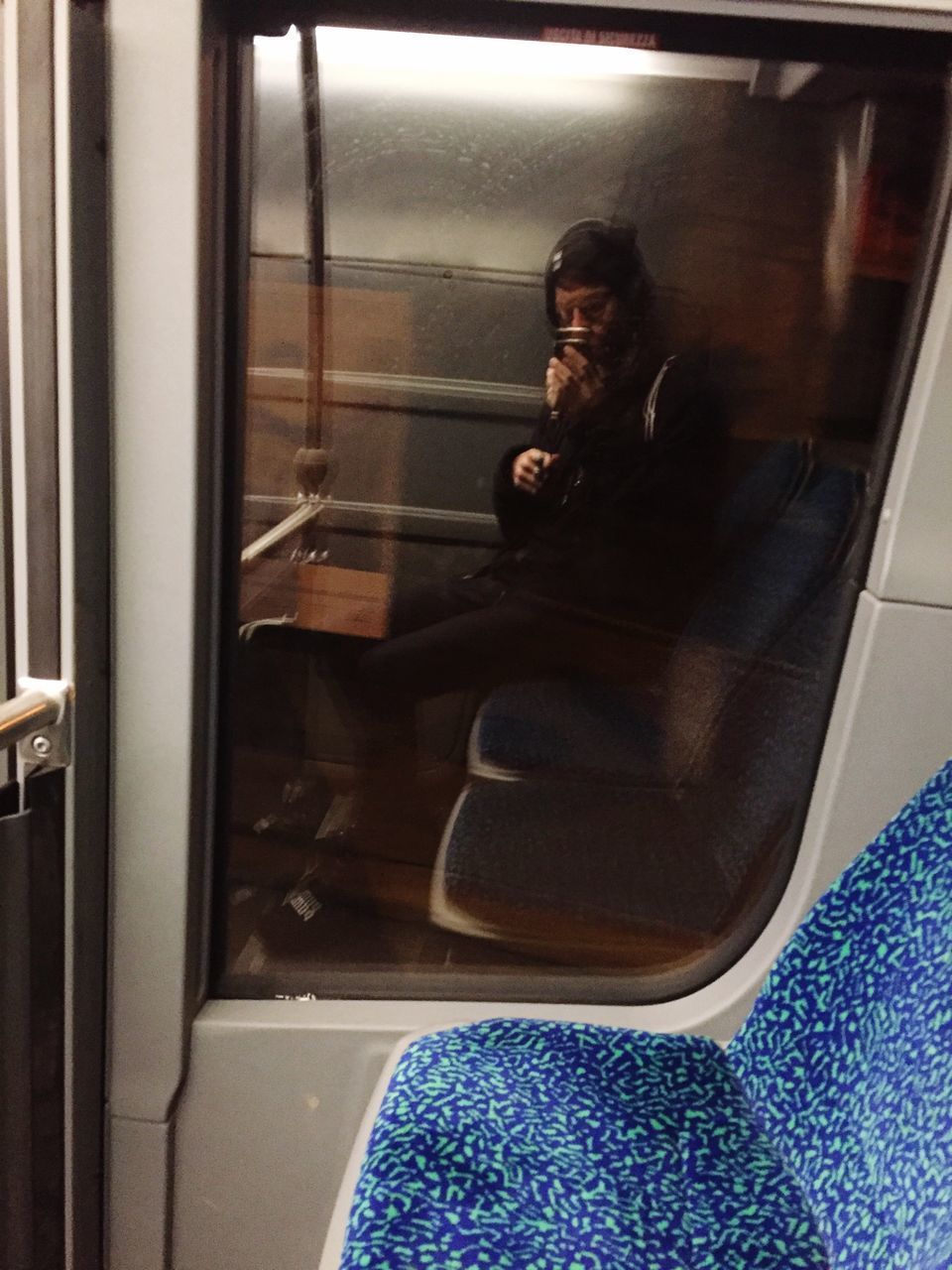 MAN SITTING IN TRAIN WINDOW