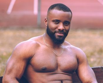 Portrait of shirtless man standing outdoors