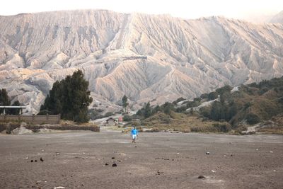 Man on field against mountain