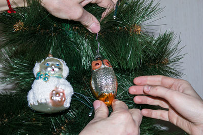 Cropped image of hand holding christmas tree