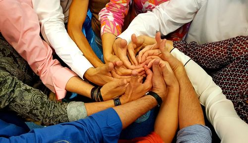 Cropped image of people making shape with hands