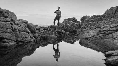 Low angle view of man standing on rock