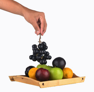 Heap of hand holding grapes over white background