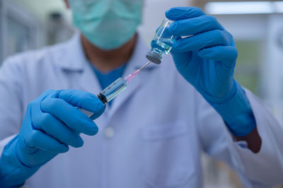 Midsection of person holding umbrella