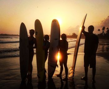 Silhouette of people standing on beach