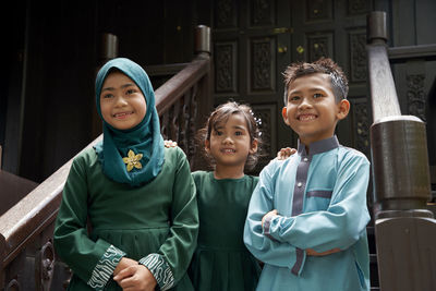 Portrait of smiling girl standing outdoors