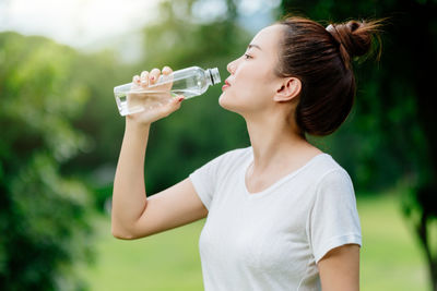 Midsection of a woman drinking glass